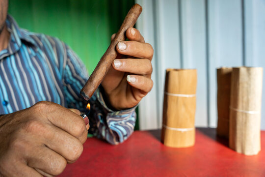 Unrecognizable Man Lighting A Cigar
