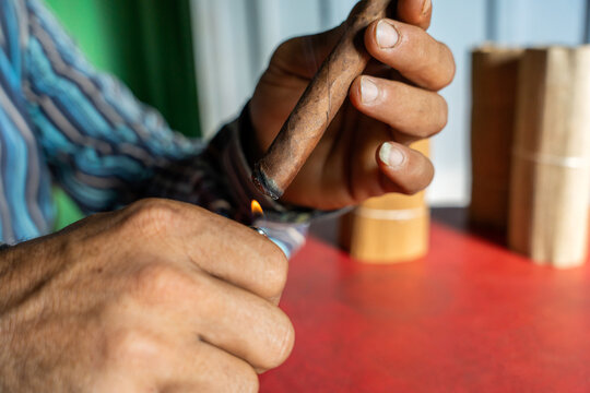 Unrecognizable Man Lighting A Cigar