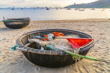 Fishing nets and equipment in a basket boat on a beach at Da Nang in Vietnam