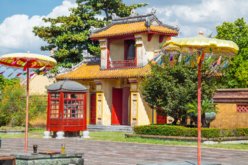 Colorful ornamental umbrellas at the gates of an ancient temple at Hue in Vietnam
