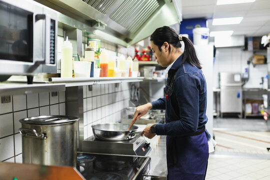 Man cooking in vietnamese kitchen