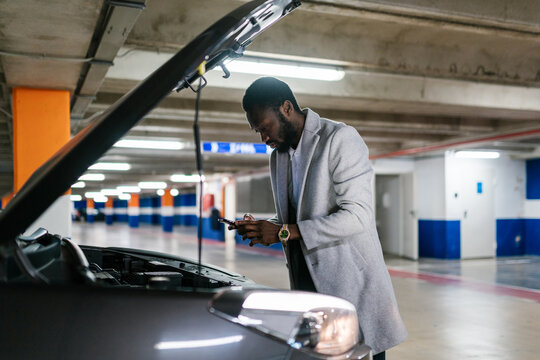 Black driver texting to mechanic