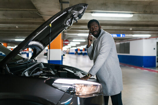 African American driver calling to technician