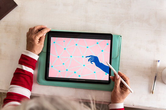 Anonymous senior uses a tablet