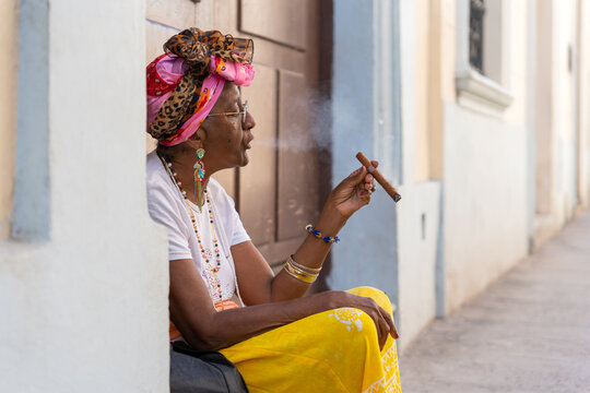 Black Woman Smoking A Cigar In Cuba.