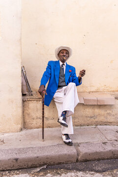 Fancy Elderly Smoker Holds A Cigar