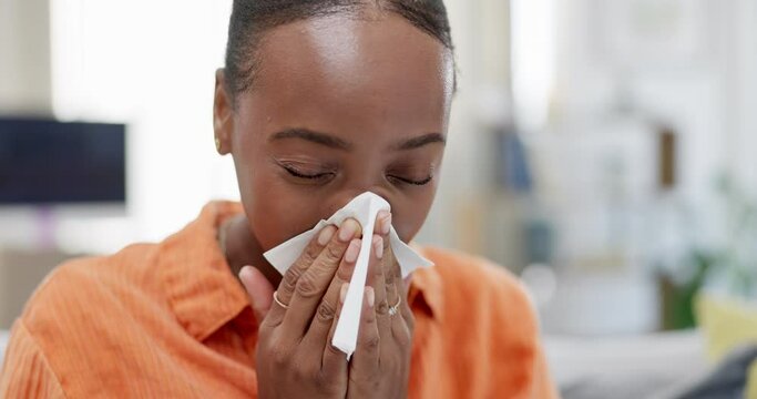 Sick black woman, tissue and nose in home for allergies, cold virus and illness girl. Sneeze, flu and allergy of female on couch from winter health problem, covid medical risk and sinusitis disease