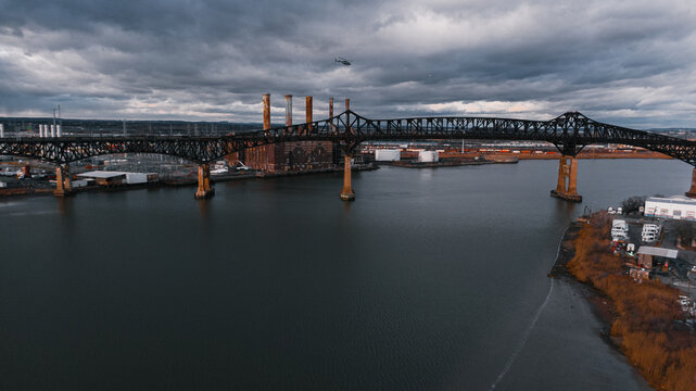Old bridge across the river and a factory on the shore