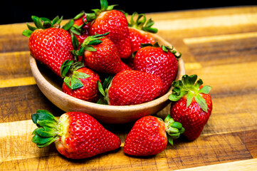 Bowl of strawberries on a wooden table