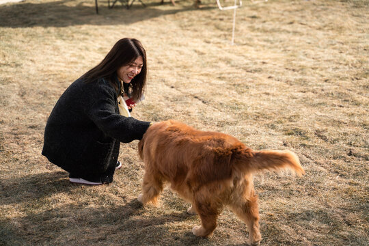 Woman Playing With Her Pet Dog