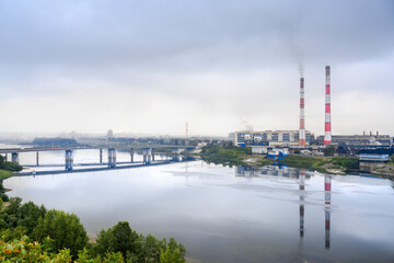 Fototapeta na wymiar View of the Tom River and the thermal power plant in Kemerovo in fog