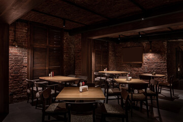 Illuminated restaurant in loft style with shabby brick walls