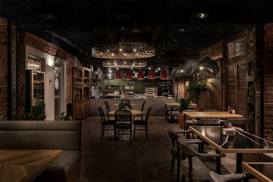 Illuminated restaurant in loft style with shabby brick walls