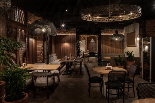 Illuminated restaurant in loft style with shabby brick walls