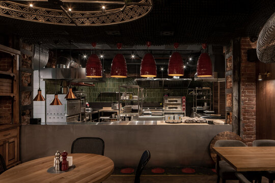 Illuminated restaurant in loft style with shabby brick walls