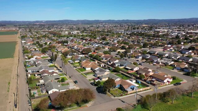 2023 - Excellent aerial footage of cars driving through a residential area in Lompoc, California.