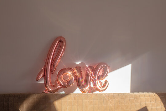 a ball in the form of Love glisten on the sofa in a beautiful light