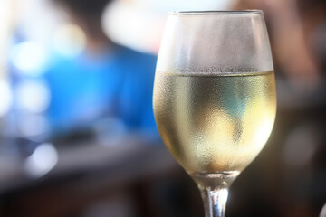 a glass of white wine in a restaurant, alcohol luxury background