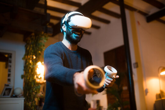 Man having fun using VR headset at home