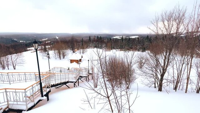 View of the chapel near the Belogorsky St. Nicholas Orthodox Missionary Monastery. Winter forest. The temple on the hill in winter. Russia, Perm Krai, Belaya Gora. 4K