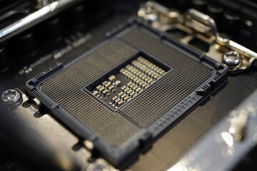 Closeup of an Intel LGA1700 CPU socket on an Asus TUF Gaming Z790-Plus Wifi motherboard without CPU...