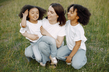Fototapeta premium Caucasian mother embracing her mixed race daughters