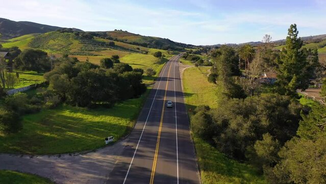 2023 - Excellent aerial footage of cars driving through greenery on a sunny day in Lompoc, California.