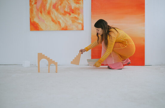 Female Artist Arranging Exhibiton in Gallery 