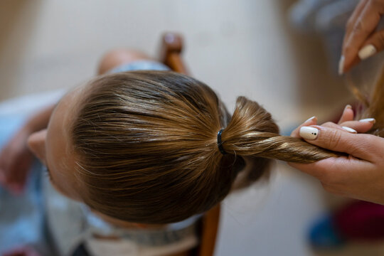 Mother Combing Her Daughter's Hair