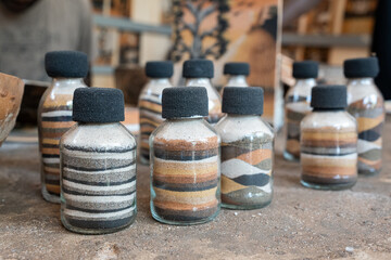 painter artist artisan creating a painting with sand