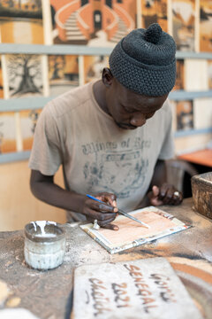 painter artist artisan creating a painting with sand