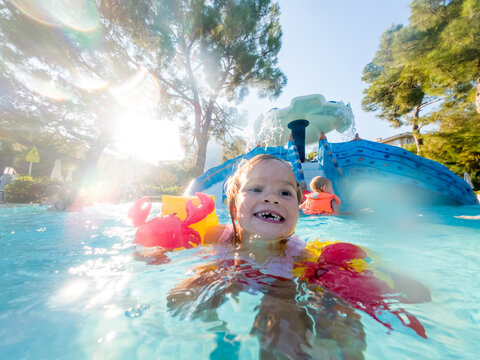 cute girl swimming in the pool