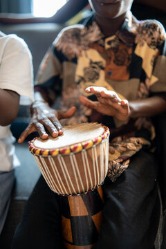 child playing the timbal at a family party at home