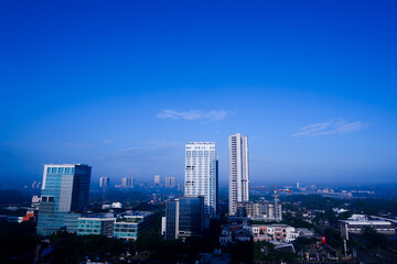 Fototapeta na wymiar View of skyscrapers against blue sky background. 