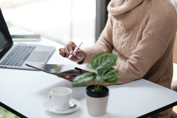 American African Woman working in the office with computer phone and Tablet.