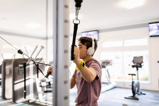 Teenager Boy muscle-building At Fit Gym