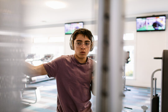 Teen boy exercising in private gym