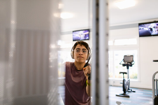 Teenager trains with a gym machine