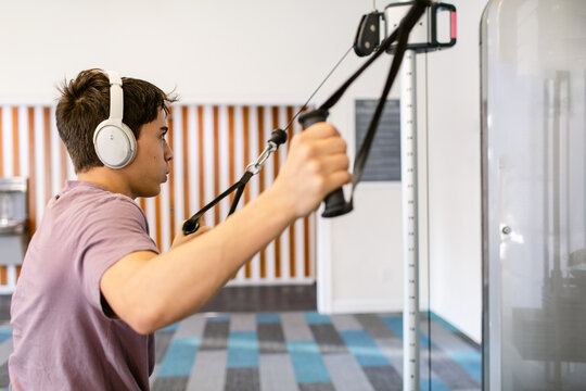 Teenager Boy muscle-building At Fit Gym