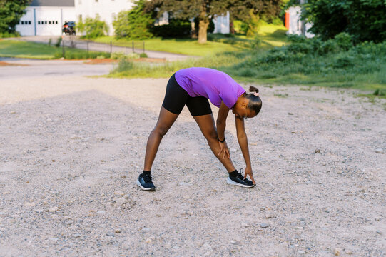 Girl stretching outdoors after her workout 