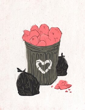 Crumpled heart in a trash bin