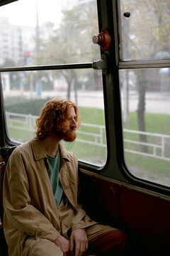 man sitting at the window of a trolleybus