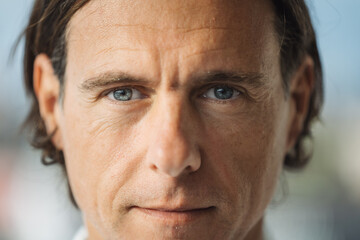 Confident middle aged man with gray eyes