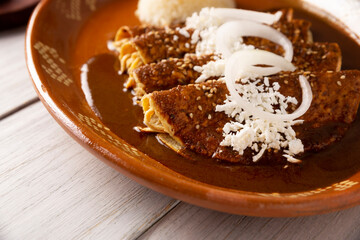 Chicken enmoladas. Also known as mole poblano enchiladas, they are a typical Mexican dish that is very popular in Mexico and the rest of the world.