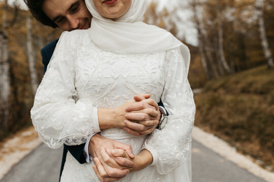 Close-up of man and woman holding hands
