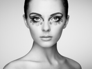 Fototapeta premium Beautiful woman face. Perfect makeup. Beauty fashion. Eyelashes. Cosmetic Eyeshadow. Black and white
