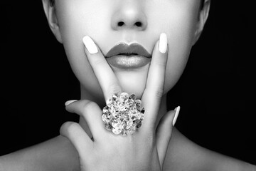 Beauty Fashion woman Lips with natural Makeup and white Nail Polish. Gloss Lipstick. Beauty girl...