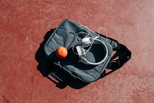 College items: bag, headphones, clementine