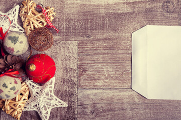 Letter for Christmas and decorations on wooden background. Xmas presents