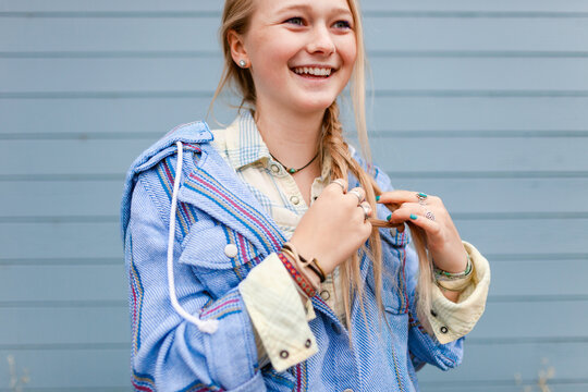 Beautiful blonde girl braiding her hair
